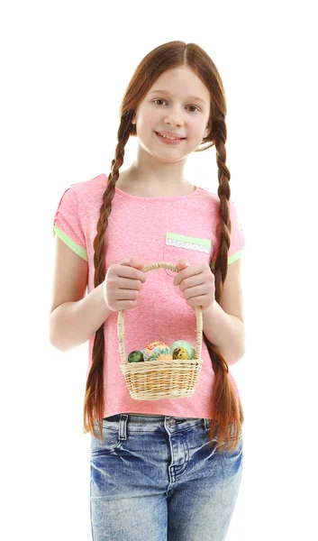 Beautiful little girl holding wicker basket with Easter eggs, isolated on white — Stock Photo, Image