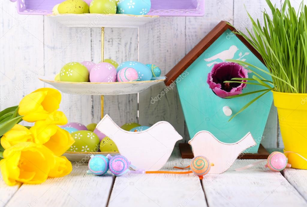 Easter decoration, eggs and tulips on table on wooden background