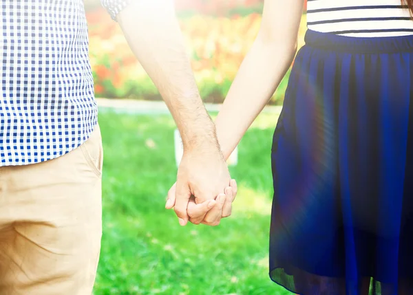 Loving couple holding hands outdoors — Stock Photo, Image