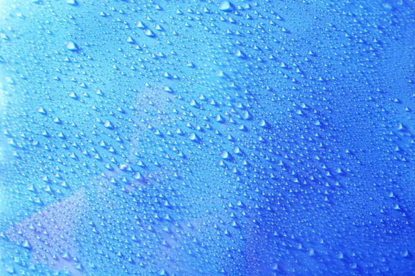 Water drops on light blue background — Stock Photo, Image