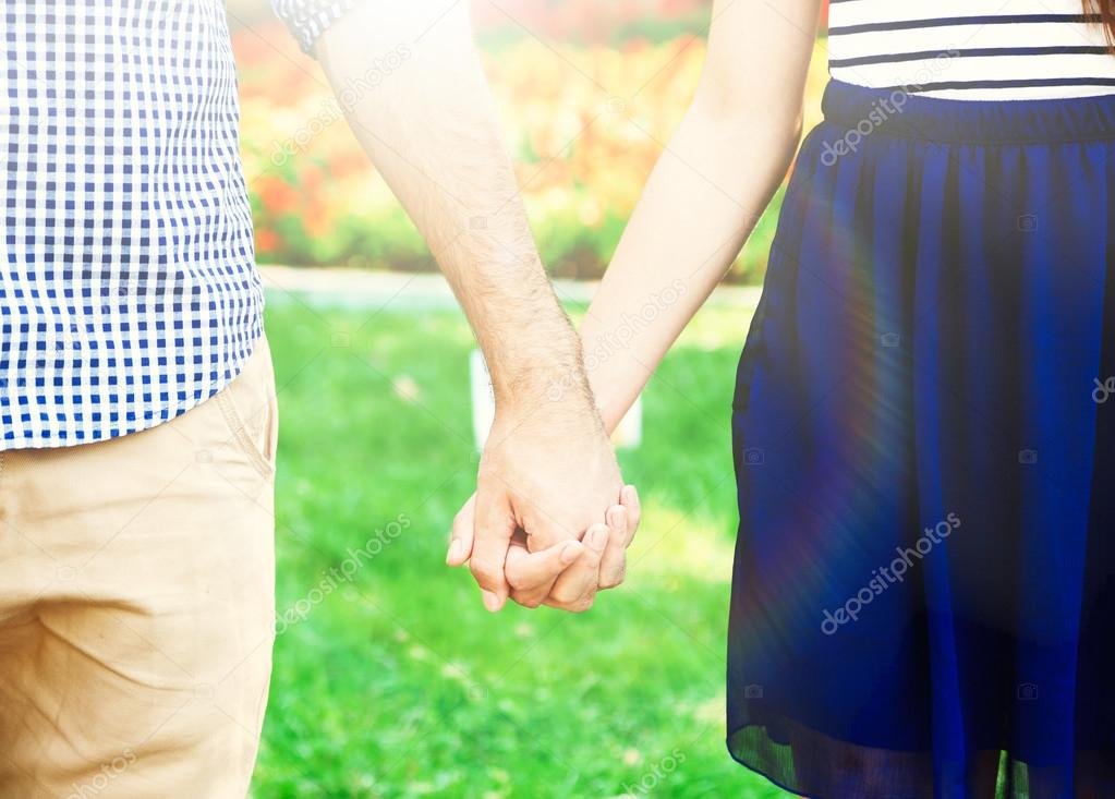 Loving couple holding hands outdoors