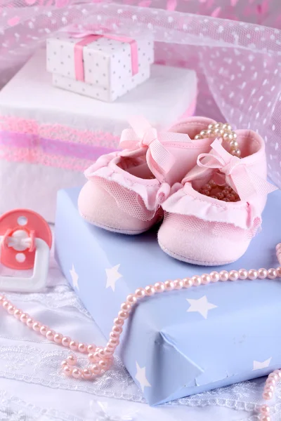Růžové dětské boty s darem detail — Stock fotografie