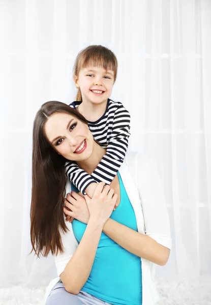 Two girls smiling on home interior background — Stock Photo, Image