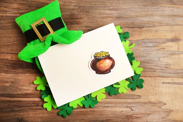 Greeting card for Saint Patrick's Day with leprechaun hat on wooden table background — Stock Photo, Image