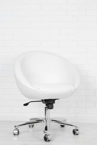 Armchair on white brick wall background — Stock Photo, Image