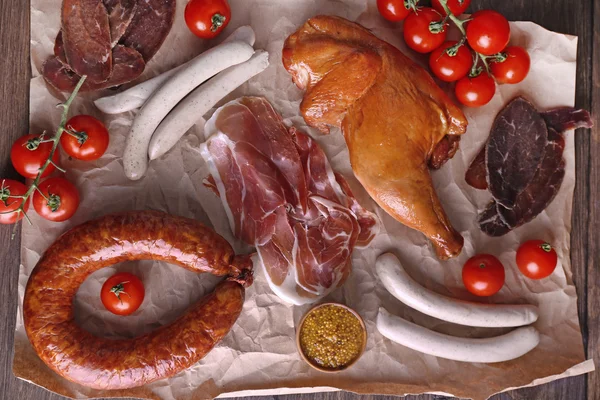 Assortment of deli meats on parchment, top view — Stock Photo, Image