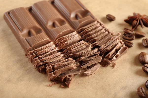 Chopped chocolate on parchment, closeup — Stock Photo, Image