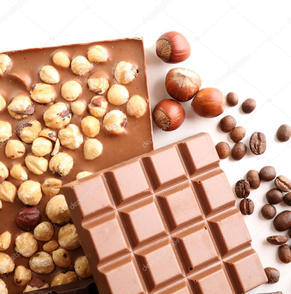 Chocolate bars with hazelnuts and coffee beans isolated on white