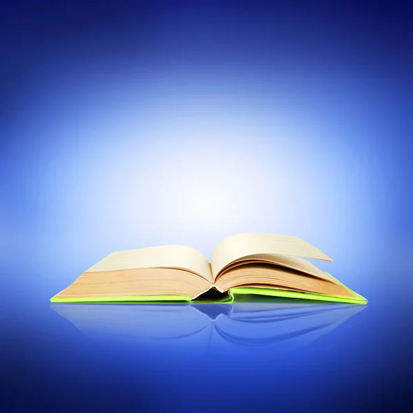 Opened book on bright blue background — Stock Photo, Image