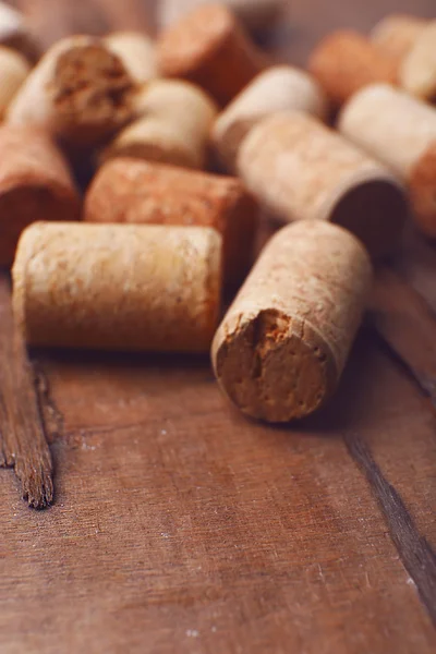 Wine corks on rustic wooden table background — Stock Photo, Image
