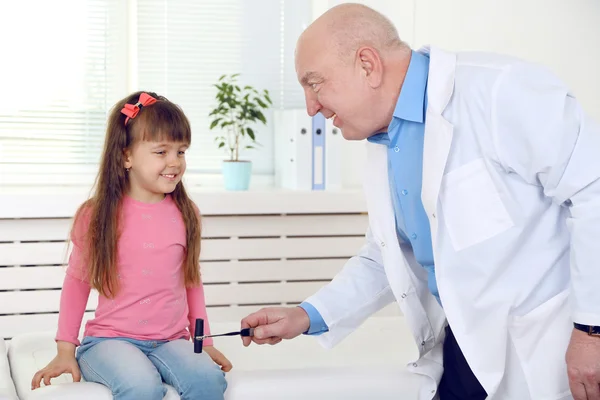 Маленькая девочка и старый врач в больнице — стоковое фото