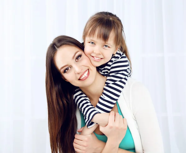 Two girls smiling on home interior background — Stock Photo, Image