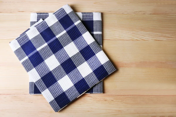 Kitchen towels on wooden background — Stock Photo, Image