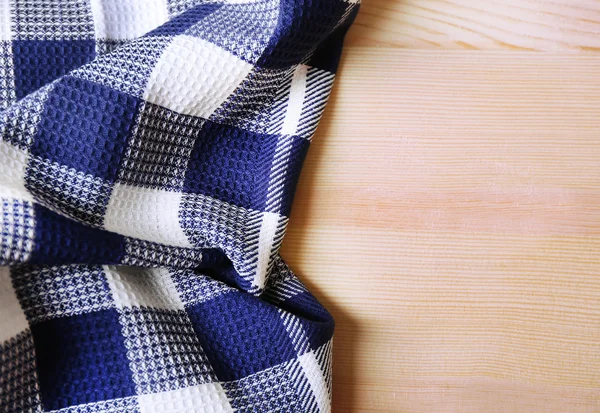 Kitchen towel on wooden background — Stock Photo, Image