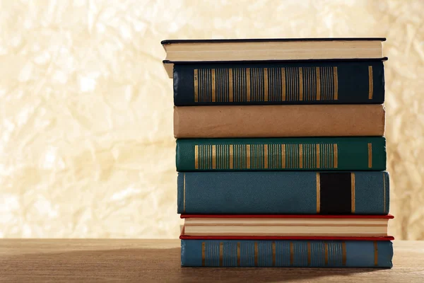 Old books on wooden table on brown background — Stock Photo, Image