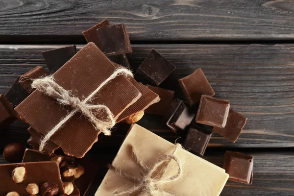 Set of chocolate with hazelnut on wooden table, closeup — Stock Photo, Image