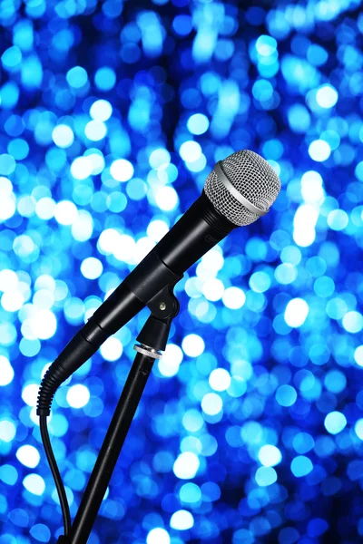 Microphone on stand on blue background — Stock Photo, Image