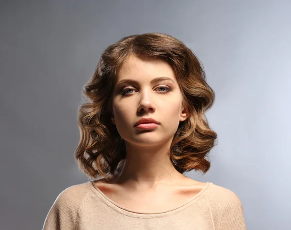 Portrait of beautiful model on gray background — Stock Photo, Image