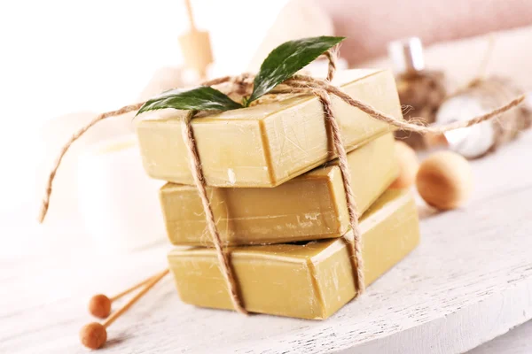 Stack of tied spa soap on wooden table, closeup — Stock Photo, Image