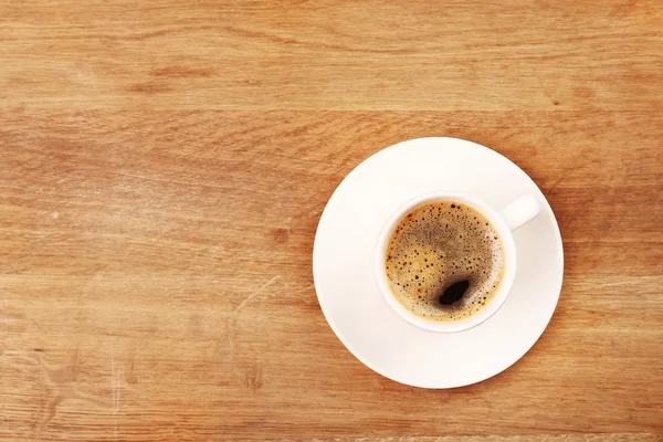 Cup of coffee on wooden table, top view — Stock Photo, Image