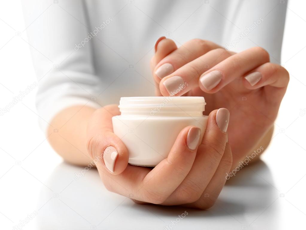 Female hands holding jar of cream isolated on white
