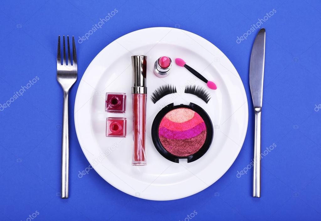 Makeup accessories on plate on colorful background