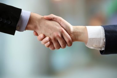 Parlak arkaplanda iş tokalaşması