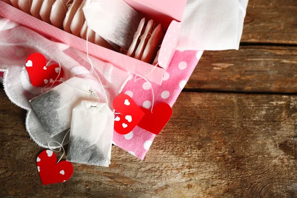 Etiqueta y caja de té en forma de corazón sobre fondo de madera — Foto de Stock