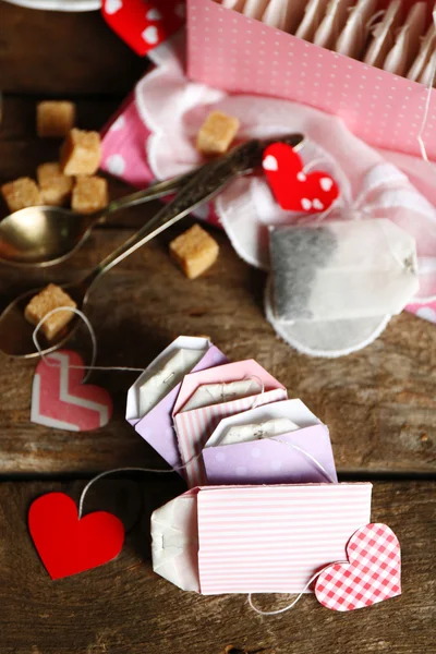 Heart shaped teabag tags and box on wooden background — Stock Photo, Image