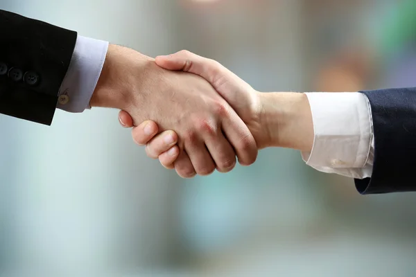 Business handshake on bright background — Stock Photo, Image