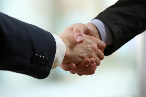 Business handshake on bright background — Stock Photo, Image