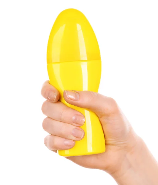 Fles zonneproducten crème in vrouwelijke hand geïsoleerd op wit — Stockfoto