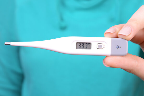 woman holding thermometer close up