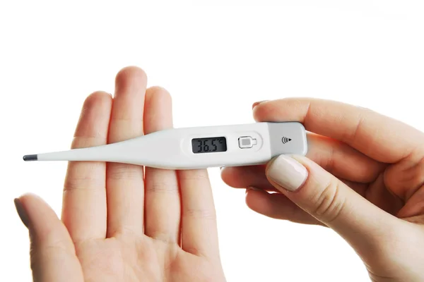 Frauenhände halten Thermometer isoliert auf weiß — Stockfoto