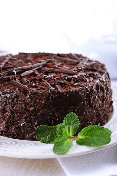 Tasty chocolate cake with mint on table close up — Stock Photo, Image