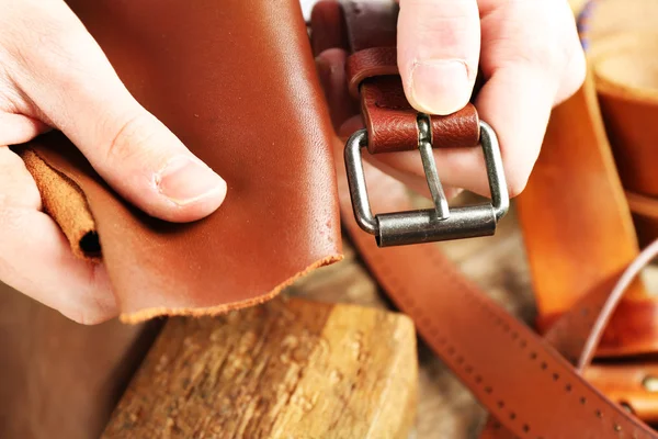 Repairing leather belt in workshop — Stock Photo, Image