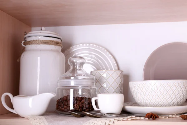 Kitchen utensils and tableware on shelf — Stock Photo, Image