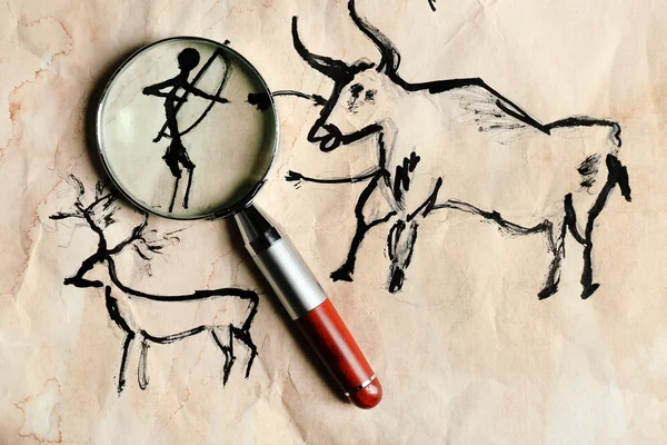 Rock paintings with magnifier on paper close up — Stock Photo, Image