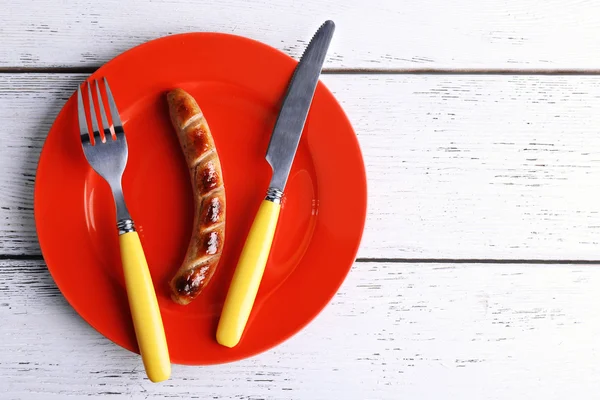 Grilled sausage on plate on table close up — Stock Photo, Image