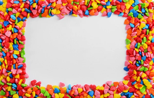 Colorful sprinkles on white background — Stock Photo, Image