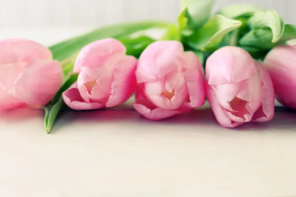 Beautiful pink tulips on wooden background Stock Image