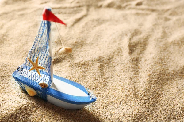 Toy model of ship on sea sand background — Stock Photo, Image