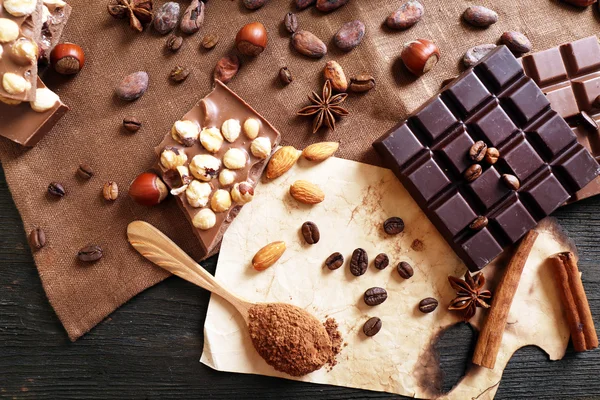 Delicious chocolates with nuts spices on table, closeup — Stock Photo, Image