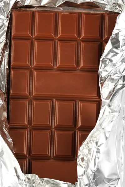 Bar of chocolate in foil, closeup — Stock Photo, Image