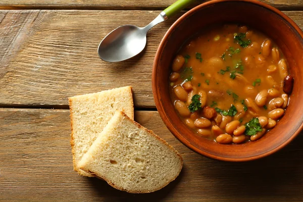 Bean soup in bowl on wooden table background — Stock Photo, Image