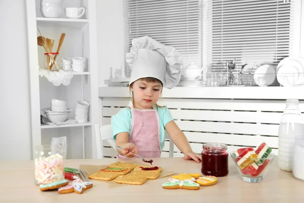 Little girl preparing cookies in kitchen at home — Stock Photo, Image