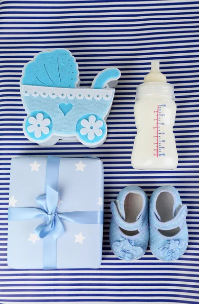 Baby shoes with baby equipment on blue background — Stock Photo, Image