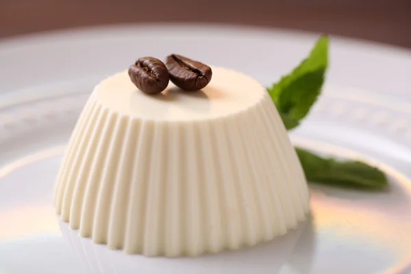 Tasty panna cotta dessert on plate, close up — Stock Photo, Image