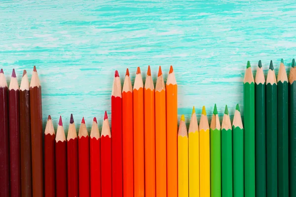 Colorful pencils on wooden table — Stock Photo, Image