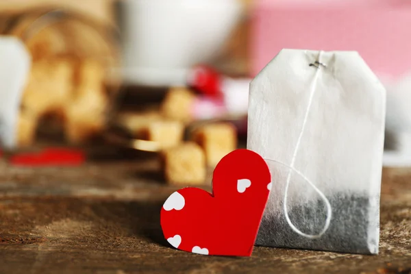 Heart shaped teabag tags and box on wooden background — Stock Photo, Image